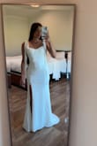 The dress fits great! The "sleeves" are a little hard to tie if you are doing it alone, but other than that, I love this dress. I'm 5'3", but I'm wearing 3" heels. - Ashlyn M.