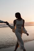 This was the dress I wore for my engagement shoot, and it truly couldn't have been more perfect for the moment. The soft cream knit felt timeless and elegant, and it matched the golden glow of the sunset in the most dreamy way. I loved how the long, simple silhouette looked against the beach backdrop, effortless but still so special. The removable sweater gave it a romantic touch that made me feel both cozy and beautiful.

The neckline is slightly frayed, which I noticed, but honestly, it didn't take away from how perfect the dress felt in that moment. It was everything I wanted. It's comfortable, elegant, and the kind of piece that lets me be fully present in one of the happiest memories of my life. - Ciera K.
