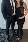 I sized down for a more snug fit. The XS fits well over my 17-week pregnant belly. Perfect length. A little see-through and thin, but didn't require a bra. I had to trim some loose strings, but overall, it worked well for the Black Tie wedding I attended. Preferred the straps up. - Megan D.