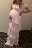 This dress is so cute! I wore it to my baby shower cause it matched the theme perfectly and it accentuated the bump perfectly! I got so many compliments on it. I ordered a small and a medium and ended up going with the small cause it fit better in the chest area, but I had lots of room for the bump! I'm 35 weeks pregnant. - Alivia C.