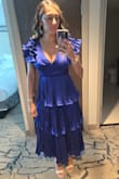 This dress was beautifully made and feels great on! The fabric does wrinkle easily, but due to all the pleats and ruffles, you can barely tell! The color is amazing and was great for the semi formal afternoon wedding I went to. It is very lowcut, so I needed to wear a low cut bra. I got so many compliments on this dress! Such a great purchase! - Summer C.