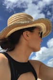Obsessed with this hat! Although it does appear to be a firm flat brim ,it indeed is somewhat floppy. It is slightly firm to shape so I placed some books on the brim on a flat surface to flatten it out. Perfect for any summer look! - Jaimie R.