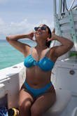 This top has a fun look that appears like you're wearing it upside down, but it has good coverage and ties securely in the back. It's hard to tell from my and the model photos, but the blue material has a glitter shine to it. I wore this on vacation in Puerto Rico for my best friend's bachelorette party and got lots of compliments on the swimsuit set. I swam and walked in this set a lot, and the top is very comfortable and never felt like it would move to expose anything. - Isabelle D.
