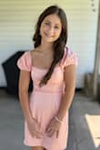 Dress is adorable in person. Fit my daughter perfectly and was very appropriate for an 8th grade social. Dress is more peach/pink. - Fallon D.