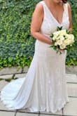 Had a low key wedding with 19 people, and the dress was perfect. I did get it hemmed due to my height. There was stretch to the dress as well. Some of the beading/sequin fell off, but can't beat the price! - Melanie S.