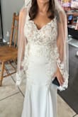 For reference, I am 4'10". I wanted a fitted, affordable and sparkly dress and decided to purchase this almost a year before my wedding date. This dress is beautiful and met all of my expectations. I had several alterations done: straps tightened, taken in at waist, switched white cups to nude, hemmed, and added bustle. Alterations were $$$ just a heads up, but very much worth it. Felt beautiful the entire day and got so many compliments. - Deanna S.