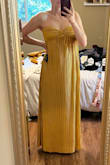 I saw this dress and loved it immediately! I ordered the yellow in a medium, and the color was just as beautiful in person. But as much as I wanted it to work, it just wasn't happening. The dress is soooo long. Even with 3 inch heels and my height, the dress was dragging (I'm on my very tip toes in this picture) and required a hem I didn't have time for.  The top was good coverage, but not tight enough for me to feel comfortable in all night and not be pulling up constantly. A strapless bra felt better, but still not as tight as I would have liked. I'm not sure that a small would have been better/more comfortable, but the fit just wasn't for me. Where the pleat gathers in the middle is also a bit awkward and bubbles. Not a huge deal, but to me it was noticeable. Otherwise - gorgeous gorgeous, but will be returning. - Mikki B.