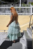 I purchased this dress to wear for church on Sundays. I wore it two weeks ago, and I got so many compliments. It's true to size and there's no stretch. The layers are very slimming; it hid my pouch completely! I feel confident in this dress. The material and the quality are great, and the straps don't slide down as long as you don't tie them too loosely. If they did untie by any chance the dress won't slide down. My only complaint is the zipper, but if you wear these types of dresses often, you know that finding a dress with a zipper that glides smoothly is rare, lol. I can't wait to wear this dress again, that's how I know I'm very happy with it. - Graciela N.