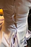 I wore this dress to one wedding and struggled from the get-go with the zipper, even though the dress fit me (it was having issues when it wasn't even on my body to be zipped and unzipped.) The zipper was getting stuck at the ruffled top part, and when I finally got it over that part, the zipper came off the tracks- luckily, someone had enough safety pins to pin the entire side of the dress! Took it to a seamstress and she said the zipper was just busted and hadn't been put on well to begin with and wouldn't be possible to replace even :( Total bummer bc the dress is otherwise super cute - Veronica P.