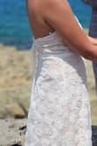 The dress is nice, but the loop for the button ripped during my wedding.  The size also runs large.  I'm usually a medium, and this dress is too big.  I had to tighten the back so much to the point you can't see the style of it. - Regina A.