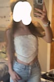 I'm going to a country concert next week, and I needed an outfit.. saw this top and thought it was perfect. It looks exactly like the picture, material is a little weird but not uncomfortable.. just wish I liked how it looks on me. - Lindsay L.