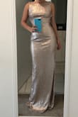 I ordered a S size and fits me perfectly. I think in pictures in lulus the dress shines more than in person. It is beautiful though. 
The only issue that I have with the dress is the length. It wasn't made for a 5"1 girl, not even if I wear high heels. Unfortunately, it will be returned. I don't want to end up on the floor. If you are taller than me, you will not be disappointed. - Angela D.