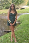 I loved my dress! It was unique from all of the other girls. The color was super pretty, emerald green with shimmery spots. It was a little short for my height, so I just wore tight shorts underneath. I would also order a smaller size next time because it puckered in the back when the laces were tied up. My mom had to stitch it up so you didn't see my shorts or underwear. Overall, I loved my dress!! - Laurie B.
