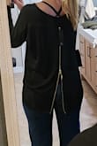 This shirt is cute and flowy. The zipper in the back is a cute detail. And the back hem is definitely low enough that it could cover your butt in leggings. The material is thin, it is a stretch to call this a "sweater". I ordered my normal size (medium) and could probably wear an XS with plenty of room. - Amanda D.
