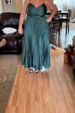 This dress is very flattering and hides all the lumps and bumps. It accentuates the waist and is very pretty. I didn't wear it to the wedding I bought it for  because I wore a different Lulus dress but my daughter stole it for a wedding she is going to! Little tight on the rib area but not uncomfortable tight. Highly recommend! - Trina W.
