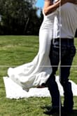 She isn't see through! It's so hard finding a cute little white dress that isn't see-through! I am on the shorter side, it did drag even with heels, but I love the dress, it was so flattering - Margie I.