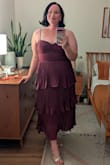 I wore this dress for a wedding with a cocktail code. I normally wear a size 16/1X in other brands, and the XXL fit just right. I agree with other reviews that the mid section would bunch, but after adjusting the strap lengths and tugging it down, that issue was solved. Also, any wrinkles came out easily with a steamer without harming the pleats. Such a fun dress! - Allison M.