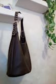 I bought this bag for everyday use. I carry around a lot.. Firstly, it is beautifully made and looks like real leather. When I first received it, it smelled like plastic, but it airs out quickly. I find this bag fits all my stuff and matches most outfits. Highly recommend! - Hannah B.