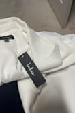 This is bright white.  Not ivory.  Description on website is misleading.  It also runs small. - Amanda A.