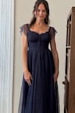 The dress features a mesh overlay on top of a stretch knit liner. It's so fun and flirty - Ashley L.