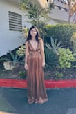 Bought this dress for a 70s theme wedding. The material is super luxurious, and it was really comfortable as well. I would size down. I'm 5'5 and 115 lbs, and ordered an XXS. The material is stretchy, so it looks really flattering when it's more fitted to the body. - Reina N.