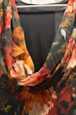 I wore this to a wedding and got multiple compliments! The dress has a two overlay, top being sheer and bottom being solid. Did not have any see through problems with black/orange flowers. The back loop lies a little weird at times, but overall has the structure. - Anya K.