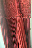 Absolutely gorgeous dress, material feels great quality, however, it is really heavy. Since it is elastic around the bust, it was falling down due to the weight of the fabric. I would have had to order a size down for it to fit nicely. The one I received was sewn incorrectly, though. The pleats were angled at the side seam, which made it pucker strangely (only on one side). This might have just been the one I received, though. - Madelyn L.