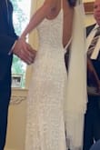Your wedding is all about YOU feeling beautiful, and this dress accomplished that for my special day. I felt simple and elegant but bridal at the same time. I did have to have extensive alterations that ended up more than tripling the actual cost of the dress, as it runs VERY large. The beads are VERY fragile. Unfortunately, by the time I walked down the aisle, numerous threads had come loose and I was shedding sequins the entire evening everywhere I went. - Maria B.