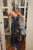 I had my eye on this dress for a while. I finally decided to purchase it and I love it! The fit is great and the material is soft and high quality. It is low cut, but the straps are adjustable. It is also very long. I will have to have it altered. The color is a true green; the picture doesn't do the color justice. I am wearing this dress on a cruise and I can't wait. - Isela G.