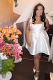 I got this dress for my bridal tea party shower, and it looked perfect! I was concerned it would be too short, but it fell right above the knee; it was a little snug on the waist without shapewear. I ordered an XL. Received many compliments, I was a little iffy in the beginning because I didn't love the way it looked on the model online, but overall it was gorgeous! - Melisa B.
