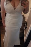 This dress fits true to size, an XL. It hugged every curve I wanted it to hug and hid every roll I wanted it to hide. I was actually pleasantly surprised to see it fit so well. It will need absolutely no alterations and fit like a glove. I truly saw myself as a bride when I put this on. - Mackenzie L.