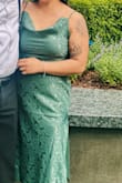 Decent quality material. Does benefit from being steamed since it's satin. True to size and has a fun slit on the left. I'm relatively short so the dress was just a couple of inches above my ankles. - Josephine C.
