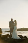 I purchased this dress for my micro wedding on the beach, and it turned out to be the perfect choice! The buttons add a chic, timeless touch, and I paired it with a lace veil that beautifully elevated the simple elegance of the gown. I would recommend sizing up, as I bought a medium, which is my usual size, but the waist runs a bit small, and I needed to have it tailored for the best fit. I had the straps adjusted and the hem shortened, and once altered, it fit like a dream. I didn't need to wear a bra, which was a pleasant surprise! Overall, I was so impressed with the quality, comfort, and look of this dress. It's especially flattering for women with a fuller bust or hourglass shape. - Kira C.