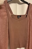 The description lists this top as "mauve". In the picture, the top looks like a cool toned, pinkish- purplish mauve. This is not the case! The top I received is a tan/brown, and the sleeves are rose gold. Even the tag says "rose gold", not mauve. If you are a cool-toned girly, opting for cooler colored clothes, know that this top is warm tan and not purple/pink/mauve lol the picture depicts! I am disappointed. - Lilah P.