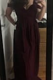 I bought this dress for my sisters wedding and I absolutely love it. It is so flattering and is just the right amount of sexy. It shows a bit of cleavage but is tight enough up top that you don't need to wear a bra. It comes in at the waist for the perfect silhouette. The little hanging straps are cute; they make the dress unique while providing an added bit of arm coverage. It needed to be hemmed, but at 5'4'' that is to be expected. - Lauren S.