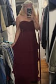 I ordered a Medium and a large because I'm normally in between sizes, and the medium looks fantastic. There is a lot of fabric for the bust area, which makes the breast area look a lot smaller than mine actually are (which I love). Very flattering dress, and the top stays up. - Madison B.