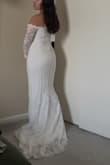 It fits so beautifully. It's a very romantic dress perfect for my Maui elopement! If you're thinking about it, get it! You won't be disappointed. Yes, the arm mobility is a little limited, but worth it. I am around 5'2 130 lbs, and it fits nicely! - Diana R.