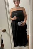 Gorgeous but plain (in a good way!) It's a tiered chiffon dress that is very flattering. I'm typically a size 18 with a bigger belly and larger breasts. This dress is perfect and hits all the curves. I did have to alter it with a seamstress but now it fits even more perfect. I ordered a 2x. I think I would have ordered a 1x but I'd rather it be bigger than too small. - Deanna H.