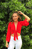 I normally wear an extra small but all that was in stock at the time was a small so I thought I'd give it a try. Let me just say, this shirt fits like a gem! You can tie it as tight or as loose as you please and the material doesn't wrinkle very easily which is a huuugeee plus! Red has never been my color but I'm so happy I gave it a try because I absolutely love it! - Lea W.