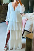This white tiered dress was exactly what I needed for an all white gala.  It is very flattering with the pleated and tiered ruffles. I have a smaller bust and had no problem without a bra, just silicone pads. I did have to add some double sided dress tape at the front v to offset any gapping while sitting. It did stretch a little in the shoulder area after wearing it. All in all, beautiful dress at a really nice price point. I do recommend. - Erin S.