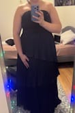 This dress is wonderful! It is perfect for a winter event cause it is layered on the bottom. I did size up worried it wouldn't fit but then altered it. I believe it is true to size. I did also change it up and wear it strapless. - Claire W.