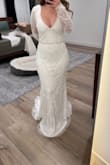 The beadwork was really beautiful on this. The neckline was just a little too low for me and I really didn't like the sleeves. It also ran large, I would size down. The belt in the photo is one I added to try and define my waist. - Jaime L.