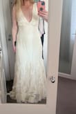 I was really disappointed with this wedding dress. The quality of the material is far below par - it feels cheap, and the straps are very poorly sewn and loose. The colour is also not as advertised; instead of a clean, elegant cream or ivory, it has a dull, yellowish tint that makes it look aged or poorly stored. Overall, the dress looked nothing like the beautiful piece I hoped for, and I wouldn't recommend it. I note that a lot of reviews had said this, and I was still hopeful because I think the style of it is so beautiful and cool and unique, but sadly, you haven't taken any of the comments on board to improve the quality. What a waste of time. I won't be ordering from this site again - Sarah F.