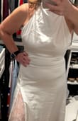 This dress is gorgeous. The material is a perfect weight satin, not too light, not too heavy. The lace slit is sexy. It has a little sweep train. I'm 5'1, and it's very long. I've decided to return because I won't have time to make the alterations before the event. I'm standing on a stool in the photos. I'm 135 and ordered a small, and it fit perfectly everywhere except the length - Dina S.