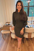 I absolutely love this dress! The olive green color is even more beautiful in person, and the ribbed knit material feels soft and comfortable. The size M fits me perfectly, hugging in all the right places without being too tight. It's versatile enough to dress up or down, and I've already received compliments every time I wear it. Highly recommend! - Camilla H.