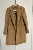 The coat isn't nearly as tailored as the picture looks. It is an oversized fit and looks really frumpy. The color is not as pictured. The quality was not great, either. You can see that the sleeves are a bit uneven as is the bottom of the coat. And the shoulder seams have a weird, uneven structure to them, almost like a mini shoulder pad with a very thick, bulky seam. I generally have great luck with Lulus and order regularly but this coat was just bad. I would absolutely return this coat if I could, unfortunately it was a final sale when I purchased it. - Christine D.