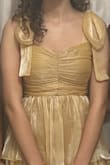 The dress design is so pretty. I love the sweetheart neckline, flowy skirt, and tieable ribbon straps! It fit a little tight on top, but it was the perfect length, so I wouldn't change sizes. The color looks less shiny gold and more yellow/orange gold, but it is still very pretty! - Pippa C.