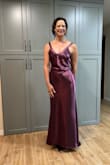 This dress is amazing! The plum color and the fit were stunning. The small train made me feel elegant. I felt like royalty for the evening and received many compliments on my gown. Forgive the vanity shots from the back.. my daughter insisted. Don't delay if you are thinking about it. Buy this gown. - Emma Z.
