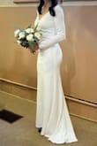 I bought this dress less than 3 weeks before our winter church wedding with 12 guests. It arrived within the week, and I had alterations done right away. I have a very muscular build, and I needed the shoulders and hips altered. I also had the seam taken in under my butt slightly to accentuate it. At 5'7 in 2" heels, I didn't need to shorten the dress, so keep that in mind if you're tall. I wish I had ordered the XS instead of the S based on the alterations I had to do, but it's what the website recommended. The dress took about an hour to steam, but it didn't wrinkle again easily. The silhouette and fit were fantastic, and the dress was comfortable to wear. I wore a sticky bra, which was perfect with how the bust was sewn. I had to buy shapewear to find underwear with a band up by my ribs. It was a thong style and only showed slightly. I got a lot of compliments, and no one believed the cost. Super happy with the purchase, and I'll need to keep doing squats until we shoot our second look. - Alanna B.