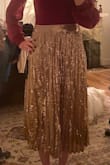 Very pretty but runs large. Skirt is mostly fitted but has some stretchy elastic on either side of zipper on the back making the fit forgiving. Stayed up but would've have gone with a small if ordering again. - Randi Y.